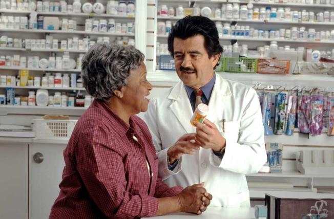 A pharmacist talking to a patient about a medication