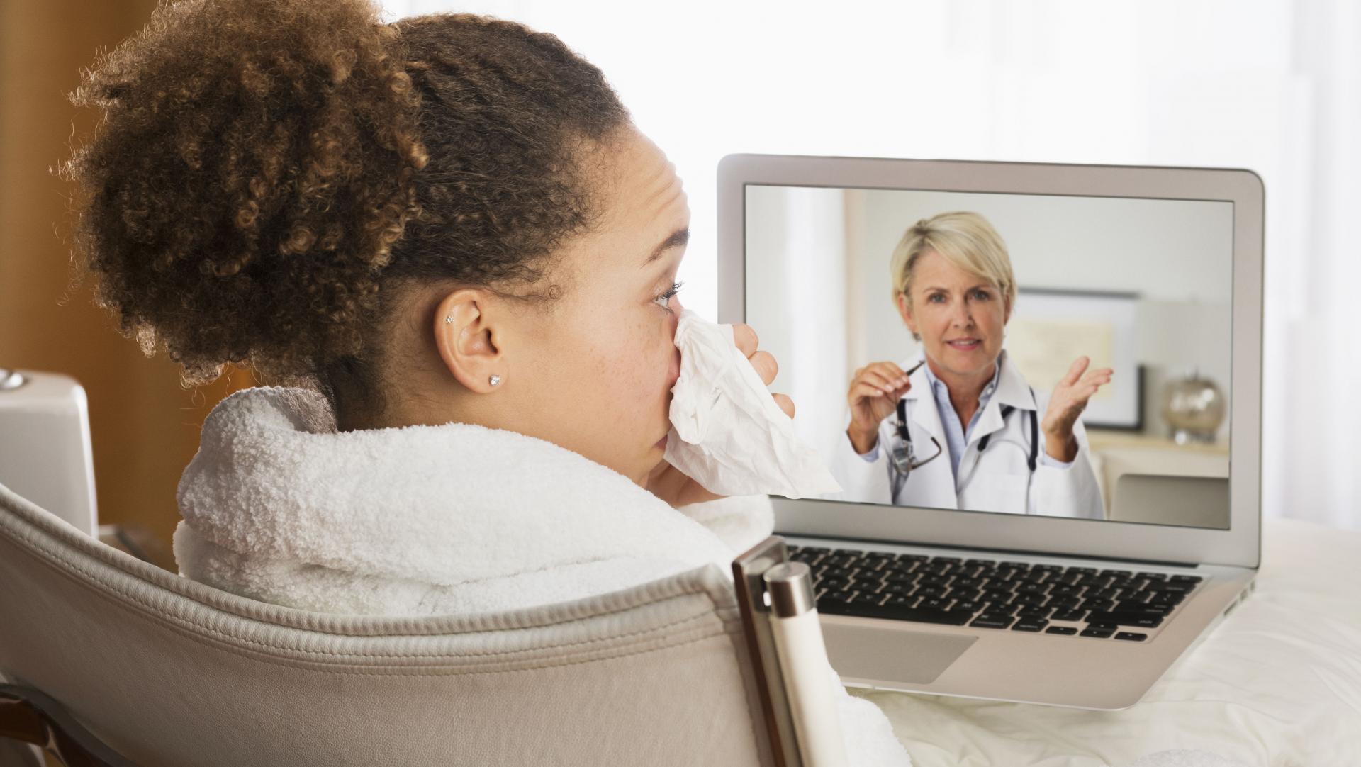 Patient with a cold having a video chat with a health provider from home